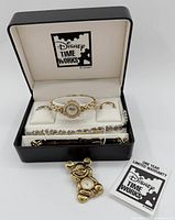 Full set displayed in black Disney Time Works box, showing gold-tone and white watch and Mickey Mouse brooch watch, with warranty booklet