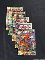 Lot of six Fantastic Four comics fanned out on black background showing covers