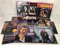 Lot of contemporary laser discs arranged in two rows showing various movie titles including Pulp Fiction, Black Rain, Interview with the Vampire, Waterworld, and Dr. No among others.
