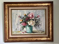 Framed oil on canvas painting of floral bouquet in turquoise vase, signed lower left.