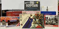 Photo showing multiple boxed sets of plastic military figures arranged on a shelf featuring 'The Egyptians' set, WWII German Infantry, Napoleonic Wars, Timpo, Pegasus, and HaT boxed sets
