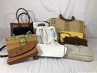 Photo showing the full assortment of 10 women's purses in various styles and colors.