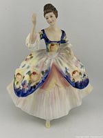 Front view of Royal Doulton Christine HN 2792 figurine in a floral period dress.