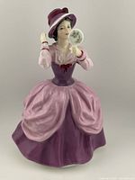 Front view of the Royal Doulton Lady Pamela figurine in purple and pink dress holding a floral hand mirror.