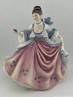 Front view of Royal Doulton Rebecca HN 2805 figurine showing full detail of dress and pose with rose in hand.