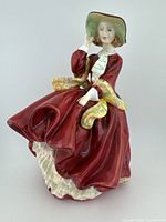 Front view of Royal Doulton Top O' The Hill figurine showing detailed dress and facial features.