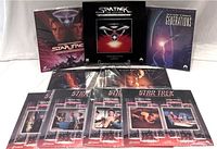 Front view of boxed laserdisc sets and sealed episode laserdiscs laid out showing cover art