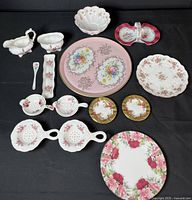 Full lot overview showing assorted china pieces including tray, bowl, creamer, cake plate, dishes, and tea bag holders.
