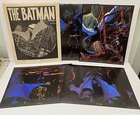 Multiple color Batman themed prints featuring Batman in action with blue and dark tones, some with Gotham cityscapes in the background.