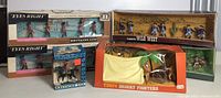 Full lot overview showing two Britains Ltd 'Eyes Right' Scots Guards boxed sets, Timpo Wild West boxed set of cowboys, Timpo Desert Fighters boxed set, and a Royal Canadian Mounted Police boxed figure.