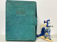 Green box with gold Walt Disney Classics Collection logo behind the figurine.