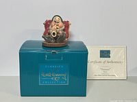 Sleepy dwarf figurine on top of blue Walt Disney Classics Collection box, Certificate of Authenticity visible in background.