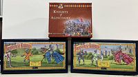Three boxed toy soldier sets arranged, including W.Britain Knights of Agincourt box and two Tournament Knights boxes.