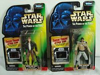 Photo showing the front of both Kenner Star Wars action figures in original packaging, with Darth Vader artwork on cards, labeled "Star Wars The Power of the Force" and featuring Freeze Frame Action Slide window.