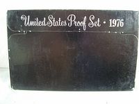 Outer black cardboard packaging with white text 'United States Proof Set 1976'. Shows shelf life wear on edges and corners.