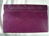 Outer purple cardboard packaging with 'United States Proof Set 1984' embossed, showing shelf wear.