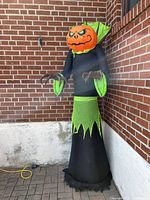 Full view of the inflatable Halloween decoration showing the pumpkin head and color details