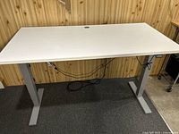 Full front view of desk showing tabletop and T-leg base