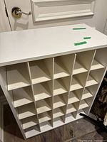 Top view of white wooden shoe rack showing 25 cubby compartments arranged in a grid for shoe storage.