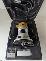 Black & Decker Deluxe Router tool inside the black plastic carrying case with power cord wrapped in the case.