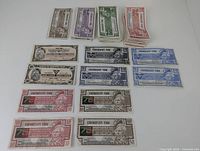 Various bills of Canadian Tire Money in different denominations and colors laid out on a white surface.