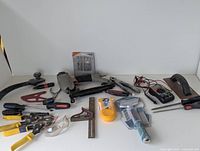 Full overview of the various hand tools including pneumatic nail gun, hand planes, pliers, screwdrivers, carpenter's square, tape measure, and multimeter.