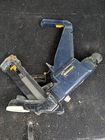 Mastercraft Flooring Nailer shown from above on black surface, visible signs of wear and dust.