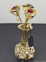Full view of the flower bouquet with 24k gold plating and pink crystal flower centers in the matching gold plated vase decorated with large clear crystals.
