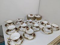 Overview of tea cups, saucers and plates arranged on table