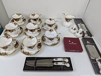 Full lot with teacups, saucers, creamer, shakers, coasters, flatware