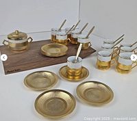 Full lot arranged showing all cups, saucers, teaspoons, sugar bowl with lid, and small plates with wood board beneath (not included).