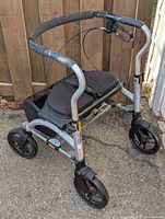 Side front angle of silver Evolution Xpresso Lite Mini walker with padded handles, seat, and front wheels.