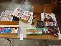 Overview of tables with binders, loose card boxes and sealed sets.