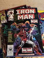 Front cover of Iron Man comic book, issue #200 showing Iron Man in red armor fighting an adversary.