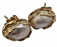 Front view of earrings showing baroque pearls set in 14k gold