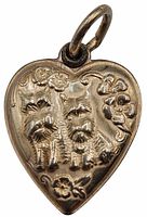 Front view of sterling silver heart charm showing repousse design with two Scottie dogs and floral details.