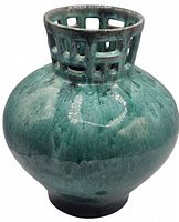 Front view of green glazed pottery vase with open lattice rim and rounded body.