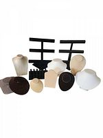 Full lot showing various jewelry display stands including busts and bracelet stands in black, white, and beige.