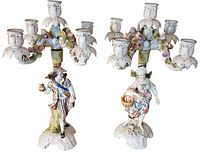 Pair of large antique Sitzendorf four branch candelabra featuring a male and female porcelain figurine with ornate floral candle holders.