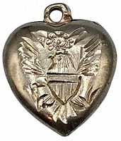 Front view of the sterling silver puffy heart charm showing embossed American eagle with shield detail.