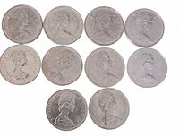 Top view photo showing ten Canadian one dollar coins laid out in two rows, front sides featuring Queen Elizabeth II profile.