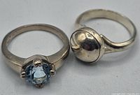 Photo of two rings side by side showing design and gemstone of one ring.