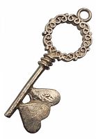 Close-up of vintage sterling silver key pendant showing entwined hearts detail and 925 marking.