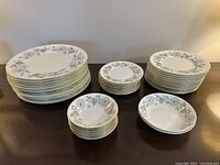 Full set arranged on table showing stacks of plates and bowls