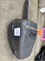 Black plastic scabbard with two wooden handled Oregon chainsaw files in metal file holder on top of case