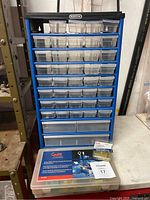 Mastercraft blue metal drawer cabinet on table with multiple small clear plastic drawers; Grote assortment kit and quick disconnect pack placed in front