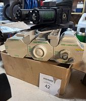 Set of CKD F4000 series filter, regulator, and lubricator mounted together on a cardboard box, showing front labels and control knobs.