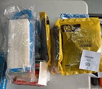 Lot overview with multiple filters, some in original packaging including the yellow Caterpillar branded bag