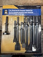 Nine-piece assorted air hammer chisel set in original packaging with various chisels for pneumatic hammer