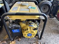 Front view of the yellow Powerfist GG1300 gasoline generator showing recoil pull start, fuel tank cap, and part of the engine.